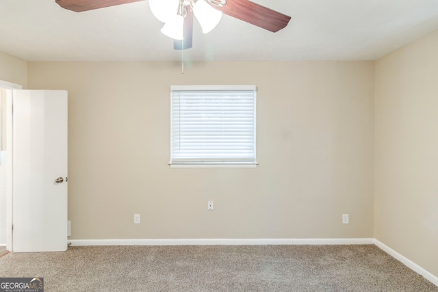 carpeted spare room with baseboards and ceiling fan