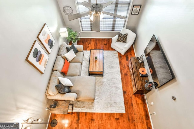 living area featuring wood finished floors and ceiling fan