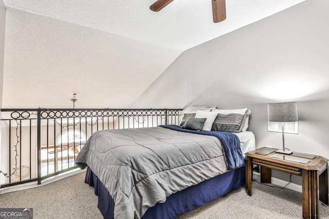 bedroom featuring carpet flooring, lofted ceiling, and a ceiling fan
