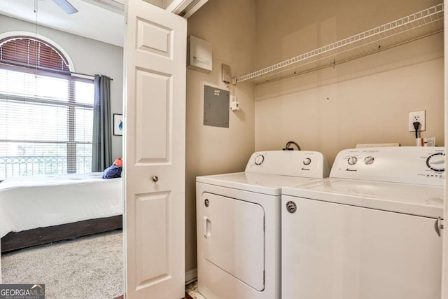 laundry room with washing machine and clothes dryer, electric panel, and ceiling fan