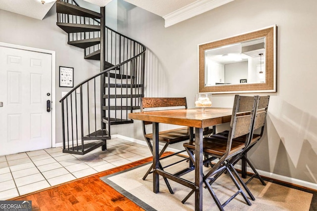 dining area with baseboards, stairs, ornamental molding, and tile patterned flooring