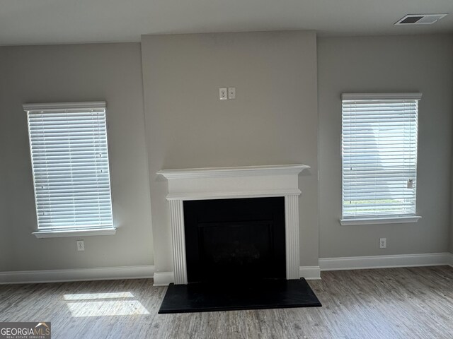 3592 Hancock Vw, Decatur, GA 30034 - room details featuring a fireplace, wood finished floors, visible vents, and baseboards