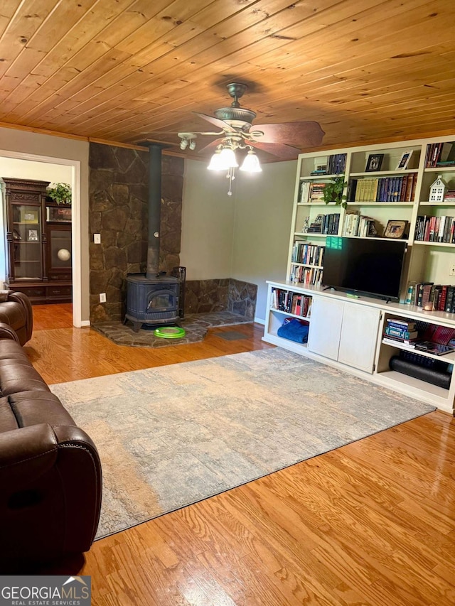 3517 Duncan Bridge Rd, Cleveland, GA 30528 - living room with wood ceiling, wood finished floors, a ceiling fan, and a wood stove