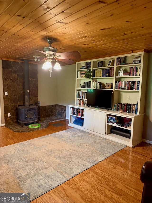 3517 Duncan Bridge Rd, Cleveland, GA 30528 - living area featuring a wood stove, a ceiling fan, wooden ceiling, and wood finished floors