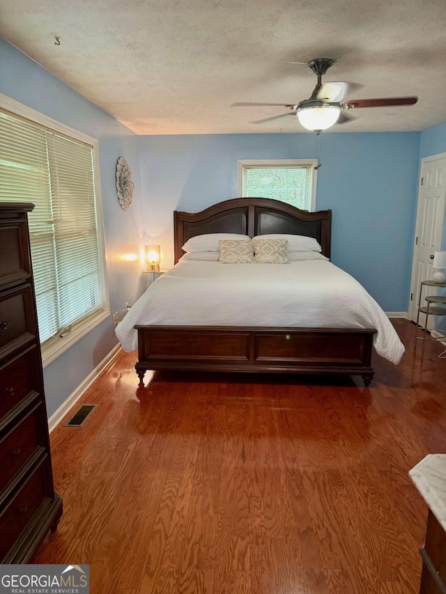 3517 Duncan Bridge Rd, Cleveland, GA 30528 - bedroom featuring a ceiling fan, visible vents, baseboards, a textured ceiling, and wood finished floors