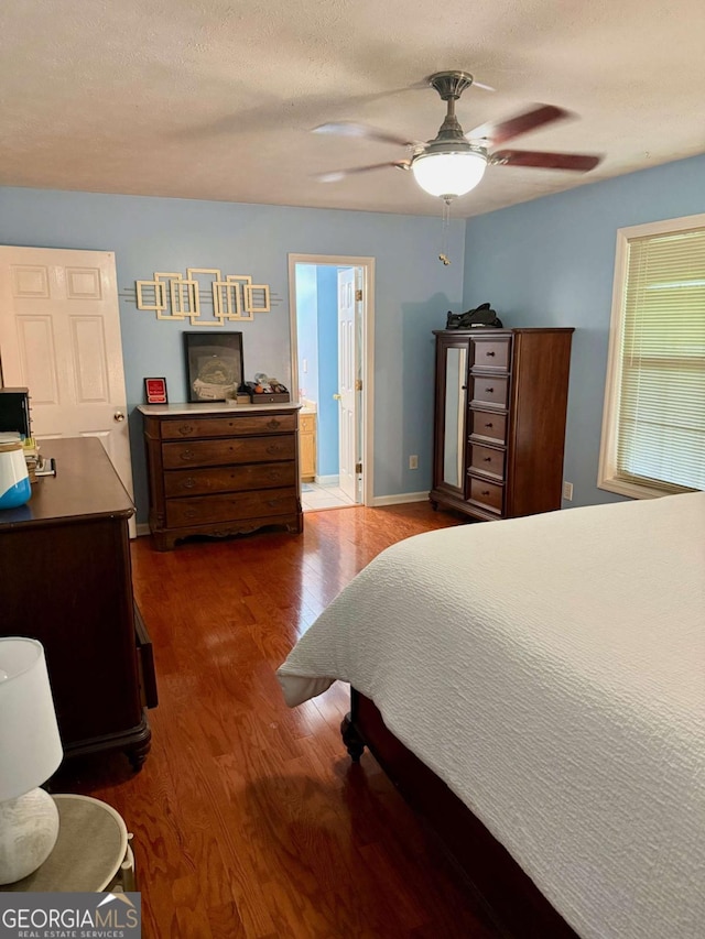 3517 Duncan Bridge Rd, Cleveland, GA 30528 - bedroom featuring wood finished floors, ensuite bathroom, baseboards, a ceiling fan, and a textured ceiling