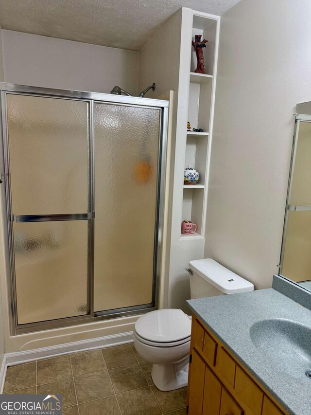 3517 Duncan Bridge Rd, Cleveland, GA 30528 - bathroom with toilet, a textured ceiling, a shower stall, and vanity