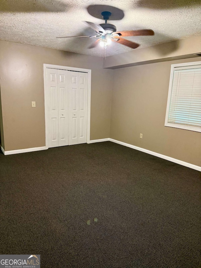 3517 Duncan Bridge Rd, Cleveland, GA 30528 - unfurnished bedroom with baseboards, a textured ceiling, carpet, and a closet