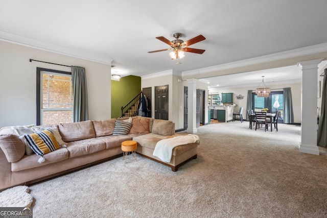 168 Constitution Blvd Unit 12, Lawrenceville, GA 30046 - carpeted living room with ornamental molding, decorative columns, stairs, a chandelier, and a ceiling fan