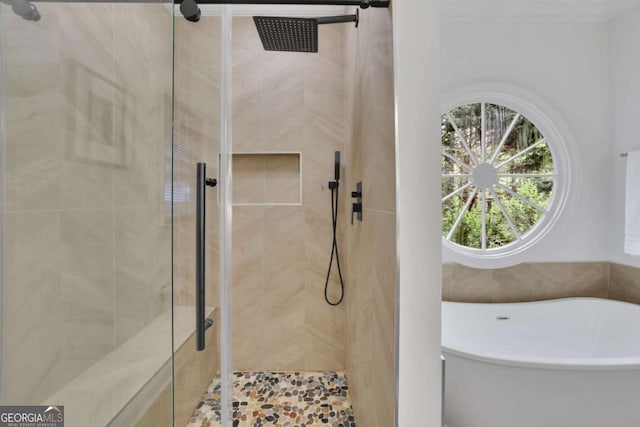 bathroom featuring a freestanding bath and a stall shower