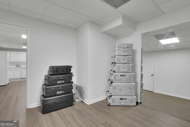 misc room featuring baseboards, visible vents, wood finished floors, and a paneled ceiling