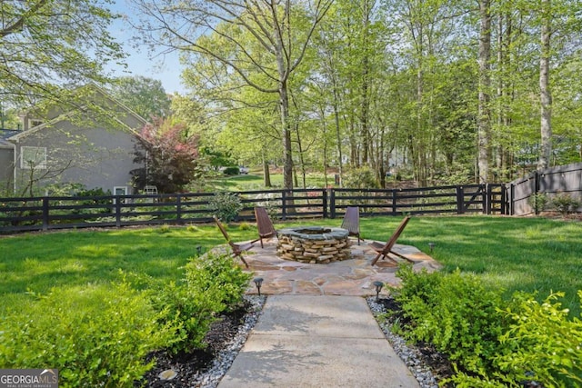 view of yard featuring an outdoor fire pit, fence private yard, and a patio area