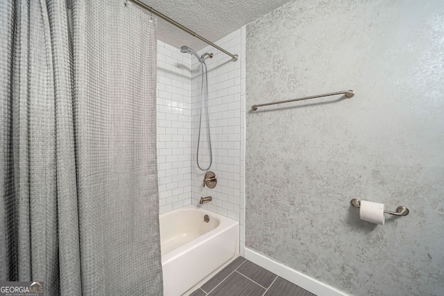full bathroom with tile patterned flooring, a textured ceiling, baseboards, and shower / tub combo
