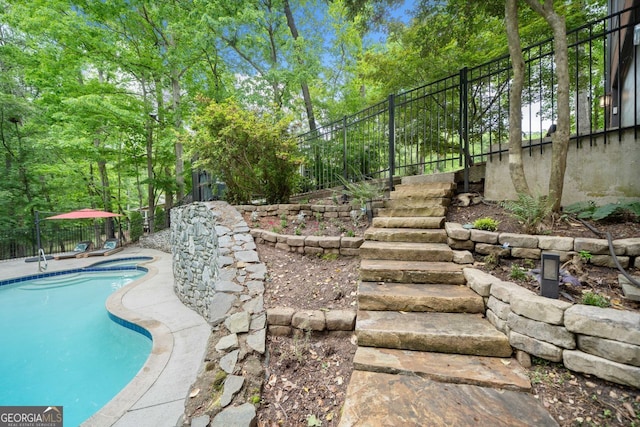 pool featuring fence and stairs