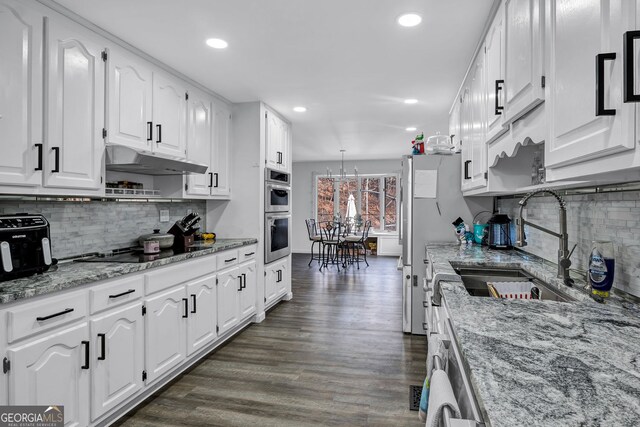 4220 Chapel Hill Farms Dr, Douglasville, GA 30135 - kitchen with a sink, under cabinet range hood, white cabinetry, recessed lighting, and appliances with stainless steel finishes