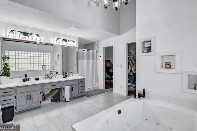 4220 Chapel Hill Farms Dr, Douglasville, GA 30135 - full bathroom featuring a stall shower, a walk in closet, double vanity, a chandelier, and a whirlpool tub