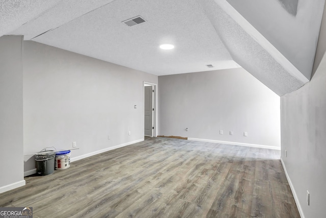 4220 Chapel Hill Farms Dr, Douglasville, GA 30135 - additional living space featuring wood finished floors, a textured ceiling, and baseboards