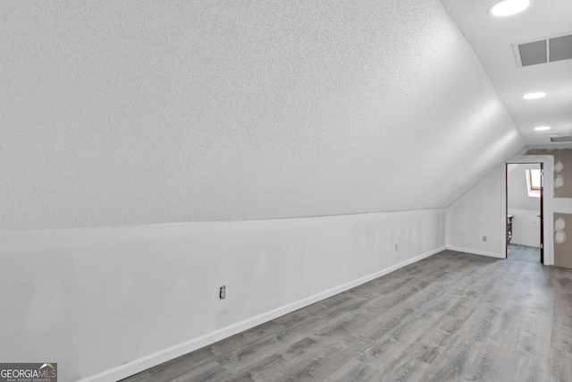 4220 Chapel Hill Farms Dr, Douglasville, GA 30135 - additional living space featuring vaulted ceiling, wood finished floors, baseboards, and recessed lighting