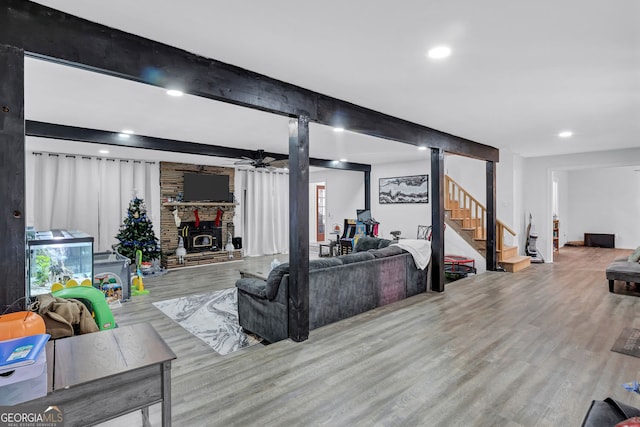 4220 Chapel Hill Farms Dr, Douglasville, GA 30135 - living room featuring wood finished floors, a fireplace, stairs, recessed lighting, and beam ceiling