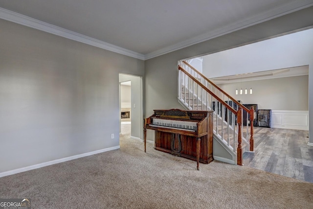 stairs featuring crown molding, baseboards, and carpet floors
