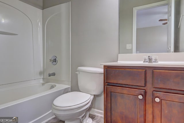 full bath with vanity, toilet, tub / shower combination, and baseboards