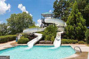 view of swimming pool with a water slide