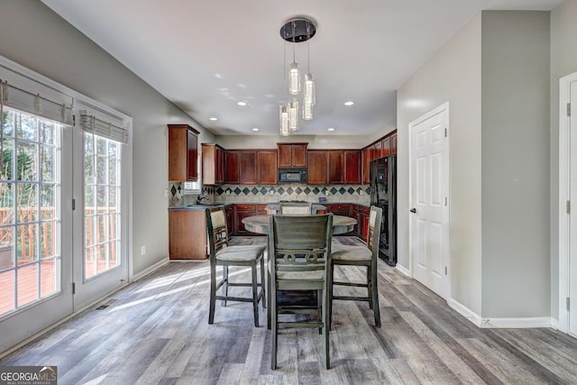 dining room with baseboards, light wood-type flooring, visible vents, and recessed lighting