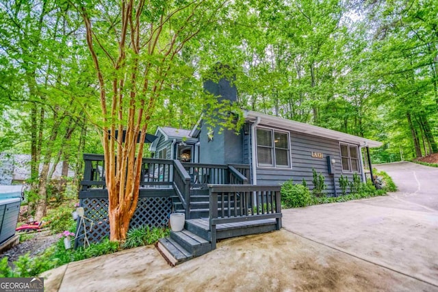 1860 Apalachee Woods Trl, Buckhead, GA 30625 - view of front of property with a chimney and a wooden deck