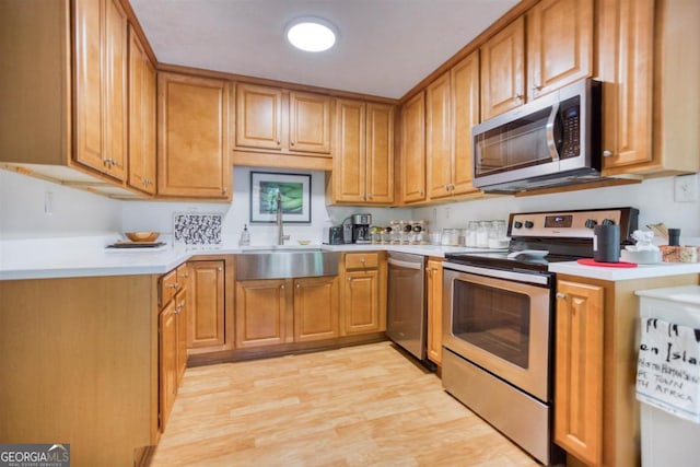 1860 Apalachee Woods Trl, Buckhead, GA 30625 - kitchen with a sink, stainless steel appliances, light countertops, light wood finished floors, and brown cabinetry
