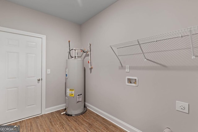 laundry room with hookup for an electric dryer, hookup for a washing machine, electric water heater, wood finished floors, and laundry area