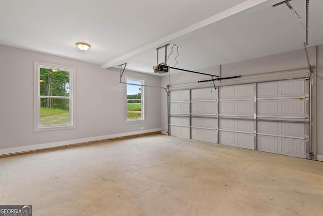 garage with a garage door opener and baseboards