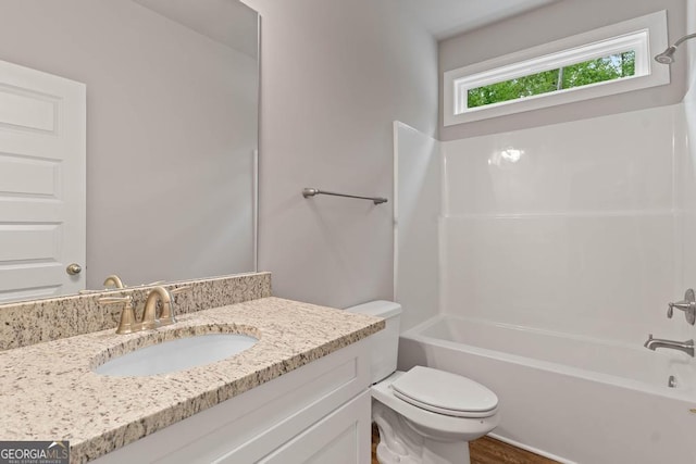 bathroom with toilet, shower / bath combination, and vanity