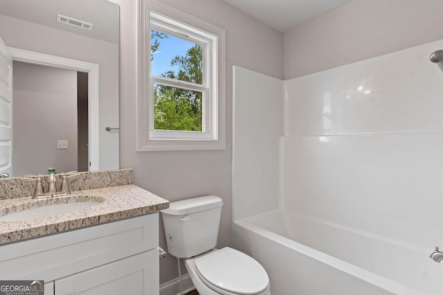 bathroom featuring visible vents, toilet, tub / shower combination, and vanity