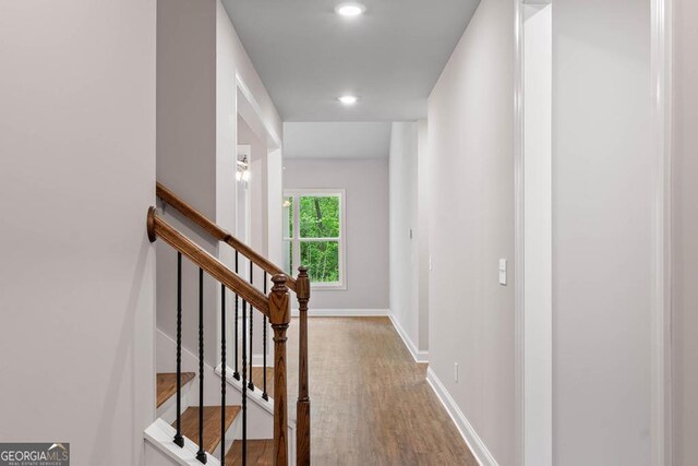 hall with recessed lighting, wood finished floors, and baseboards