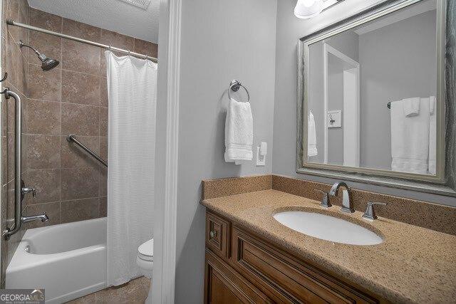 2508 Demere Rd Unit 2, Saint Simons, GA 31522 - bathroom featuring shower / bath combination with curtain, toilet, and vanity