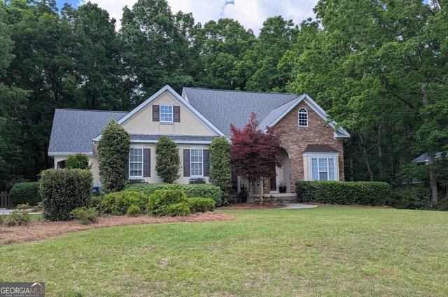 169 Cambridge Way, Macon, GA 31220 - traditional home with a front yard, a shingled roof, stone siding, and stucco siding