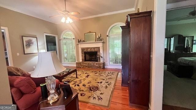 169 Cambridge Way, Macon, GA 31220 - living room featuring a ceiling fan, wood finished floors, a stone fireplace, and crown molding