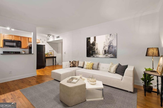 798 Saint Charles Ave NE Unit 7, Atlanta, GA 30306 - living room with light wood-style floors, crown molding, and baseboards