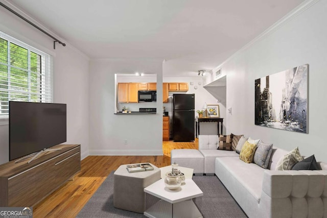 798 Saint Charles Ave NE Unit 7, Atlanta, GA 30306 - living room with light wood-style floors, crown molding, visible vents, and baseboards