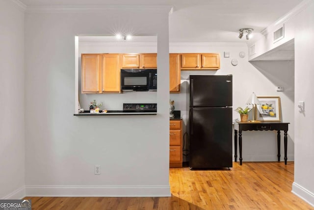 798 Saint Charles Ave NE Unit 7, Atlanta, GA 30306 - kitchen with baseboards, light wood-type flooring, black appliances, and crown molding