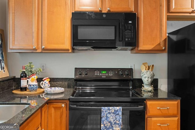 798 Saint Charles Ave NE Unit 7, Atlanta, GA 30306 - kitchen featuring dark stone counters, black appliances, and brown cabinetry