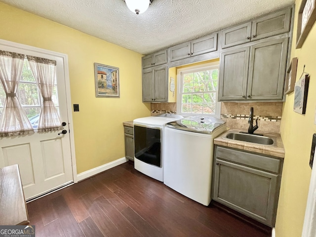 4614 Capers Xing W, Peachtree Corners, GA 30092 - laundry room with dark wood-style flooring, cabinet space, a sink, baseboards, and washer and clothes dryer