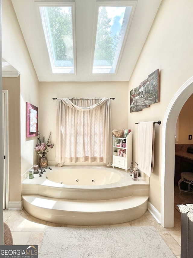 4614 Capers Xing W, Peachtree Corners, GA 30092 - full bath featuring tile patterned flooring, a tub with jets, and lofted ceiling with skylight