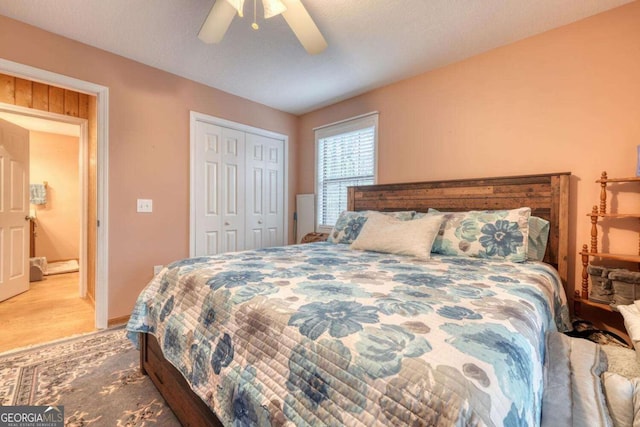 bedroom with wood finished floors, ceiling fan, and a closet
