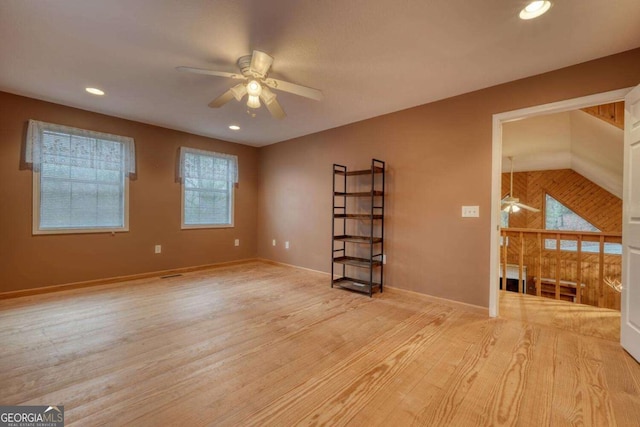 spare room featuring a healthy amount of sunlight, recessed lighting, wood finished floors, and a ceiling fan