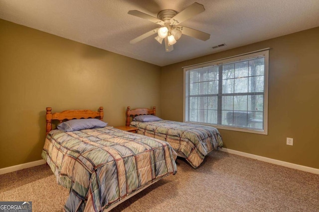 bedroom featuring a textured ceiling, visible vents, ceiling fan, baseboards, and carpet floors