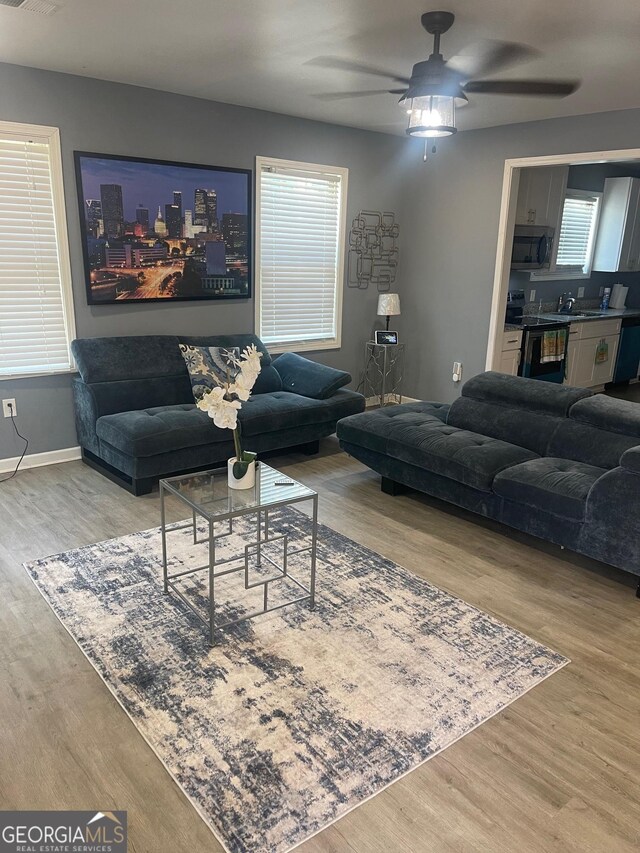1962 Markone St NW, Atlanta, GA 30318 - living area featuring wood finished floors, ceiling fan, and baseboards