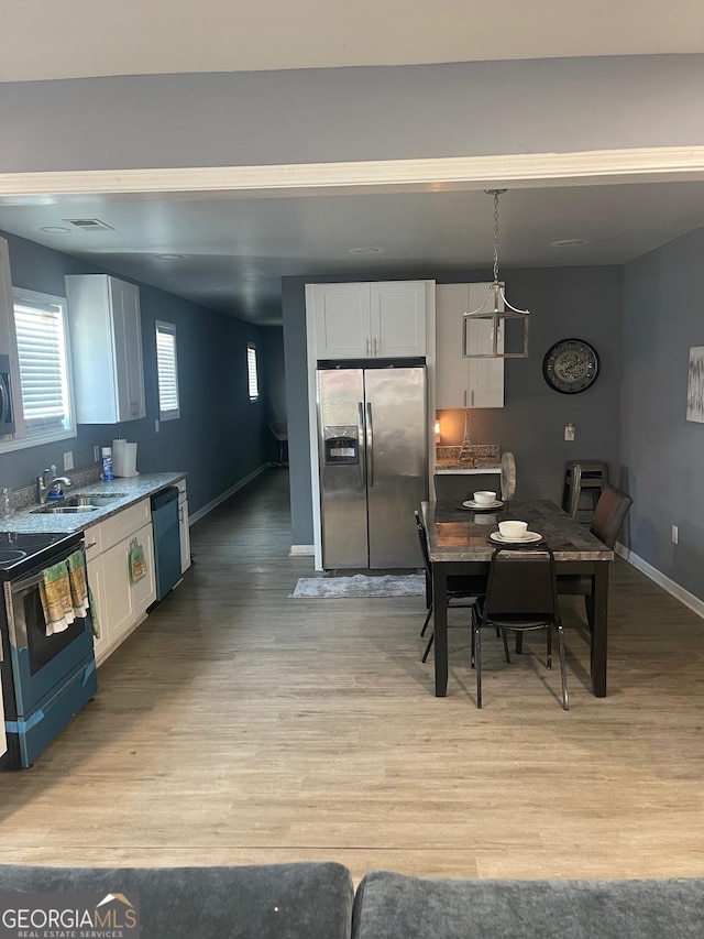 1962 Markone St NW, Atlanta, GA 30318 - kitchen with stainless steel refrigerator with ice dispenser, white cabinetry, electric stove, and light wood finished floors