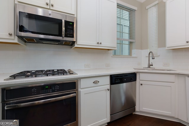 569 Mirrormont Dr SE, Smyrna, GA 30080 - kitchen with stainless steel appliances, white cabinets, healthy amount of natural light, and backsplash