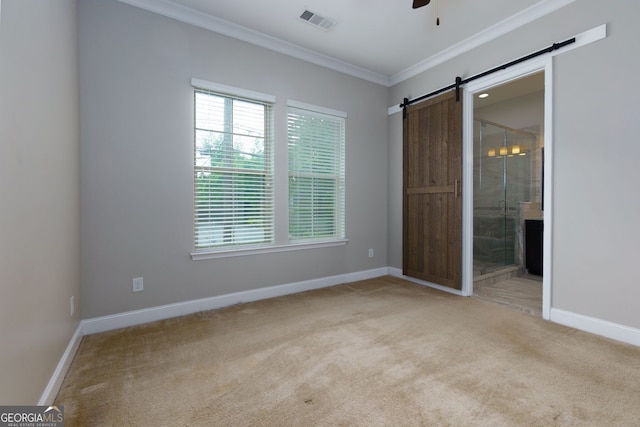 569 Mirrormont Dr SE, Smyrna, GA 30080 - unfurnished bedroom with ornamental molding, a barn door, carpet, ensuite bathroom, and ceiling fan